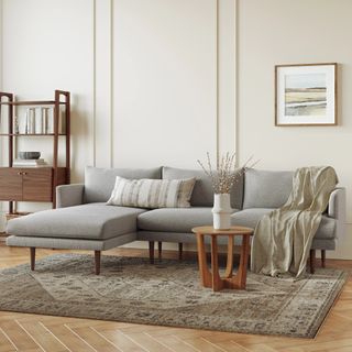 The Sophisticate Bundle, contains products [Burrard 112" Left Sectional - Seasalt Gray] and [Tovi Side Table - Smoked Oak].